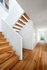 Modern home with Staircase and Wood Tread. This view would not have been possible before the renovation, as there was no clear path between inside and outside without going through a bedroom. We created a breezeway that links the side courtyards. We also replaced the stair with an open-riser stair, and added skylight to bring more light from above. Photo 6 of Waterfront House