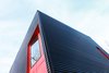 Modern home with Exterior, Shed RoofLine, House Building Type, Metal Roof Material, and Metal Siding Material. The 2-story black metal cube is sliced by red hot gashes. Photo 2 of The Woung House