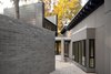 Modern home with Exterior, Metal Siding Material, Brick Siding Material, Metal Roof Material, Concrete Siding Material, Shed RoofLine, and House Building Type. In homage to the courtyard wall of Lorraine’s Jamaican childhood home, this unique concrete block structure is sequenced to guide one into and through the residence. Photo 3 of The Woung House