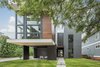 Modern home with Exterior, House Building Type, Wood Siding Material, Glass Siding Material, Flat RoofLine, and Concrete Siding Material. Two volumes are separated by the open foyer. Living on the left, sleeping on the right. Photo 3 of Gillingham Strauss Residence