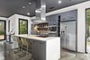 Modern home with Kitchen, Engineered Quartz Counter, Wall Oven, Mosaic Tile Backsplashe, Range Hood, Cooktops, Microwave, Concrete Floor, Ceiling Lighting, Dishwasher, Undermount Sink, Pendant Lighting, Refrigerator, and Accent Lighting. kitchen Photo 4 of 1908 Oaklawn