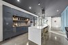 Modern home with Kitchen, Engineered Quartz Counter, Concrete Floor, Wall Oven, Microwave, Open Cabinet, Dishwasher, Refrigerator, Ceiling Lighting, Undermount Sink, Mosaic Tile Backsplashe, Range Hood, Pendant Lighting, and Cooktops. kitchen Photo 5 of 1908 Oaklawn