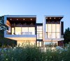 Modern home with Exterior, Flat RoofLine, House Building Type, Glass Siding Material, Metal Siding Material, Metal Roof Material, and Wood Siding Material. Located in the south end of Halifax, Nova Scotia, Syncline was designed by Omar Gandhi Architect. The quiet, masculine modern form sits adjacent to Point Pleasant Park and overlooks the North-West Arm. Photo of Syncline