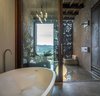 Modern home with Bath Room, Concrete Floor, Freestanding Tub, Open Shower, Floor Lighting, Concrete Wall, Drop In Tub, and Ceiling Lighting. Master bathroom with views to the valley-VILLA CP Photo 10 of Villa CP