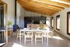 Modern home with Dining Room, Table, Chair, Stools, Lamps, Ceiling Lighting, Concrete Floor, Standard Layout Fireplace, and Gas Burning Fireplace. Dinning room-VILLA CP Photo 15 of Villa CP