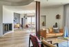 Modern home with Living Room, Standard Layout Fireplace, Light Hardwood Floor, Pendant Lighting, Ceiling Lighting, Coffee Tables, Sofa, and Chair. Creueta House-Living room. Photo 6 of Creueta House