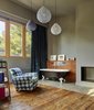 Modern home with Bedroom, Chair, Pendant Lighting, Ceramic Tile Floor, Ceiling Lighting, Medium Hardwood Floor, and Shelves. Creueta House-Master bedroom. Photo 11 of Creueta House