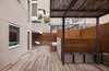 Modern home with Living Room, Ceiling Lighting, Bookcase, Light Hardwood Floor, Wall Lighting, and Chair. Duplex in Gracia-living room Photo 11 of Duplex in Gracia