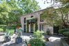 Modern home with Outdoor, Side Yard, Stone Patio, Porch, Deck, Pavers Patio, Porch, Deck, Hardscapes, Trees, and Stone Fences, Wall. Large, meticulously landscaped courtyard Photo of The Hill Gowdy House