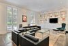 Modern home with Living Room, Chair, Sofa, Coffee Tables, Bookcase, Slate Floor, Gas Burning Fireplace, and Recessed Lighting. Open living room with French doors leading to the private courtyard Photo 2 of The Hill Gowdy House
