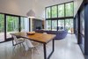 Modern home with Living Room, Recessed Lighting, Concrete Floor, Pendant Lighting, Sofa, and Wood Burning Fireplace. Lake House Photo 3 of Lake House
