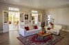 Modern home with Living Room, Sofa, Ceiling Lighting, Laminate Floor, and Wood Burning Fireplace. The lounge opens up to the "braai" area (afrikaans to BBQ, the most important part of the house in South Africa :-) Photo 11 of Old Victorian home is fully renovated and becomes a dream property