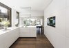 Modern home with Kitchen, Wall Oven, White Cabinet, Pendant Lighting, Range Hood, Dark Hardwood Floor, Recessed Lighting, and Cooktops. The all-white kitchen has an L-shaped work area and several cupboards. The work surfaces and cabinets are made of Corian, which gives the kitchen a soft elegance that blends beautifully with the oak parquet and the black steel wall. The highlight is the corner window seat.
Photo 11 of Object 336 - beautiful blackbox