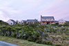 Modern home with Exterior, House Building Type, Shingles Roof Material, Wood Siding Material, and Gable RoofLine. A street view of the residence. Photo of Eel Point Road Residence