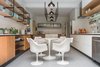 Modern home with Kitchen, Refrigerator, Dishwasher, Microwave, Wall Oven, Wood Counter, White Cabinet, and Terrazzo Floor. kitchen Photo 7 of Casa Milton