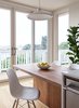 Modern home with Kitchen, Dishwasher, Engineered Quartz Counter, Wood Counter, Light Hardwood Floor, and Pendant Lighting. Floor to ceiling windows brighten the small footprint. Custom elm wood table by Kaimade. Photo 4 of Los Palmos