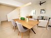 Modern home with Dining Room, Table, and Medium Hardwood Floor. Open floor plan concept with wood flooring and modern fixtures. Photo 2 of Stacks Modern