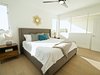 Modern home with Bedroom, Dresser, Bed, Ceiling Lighting, Medium Hardwood Floor, Night Stands, and Table Lighting. Master suite with ample natural light and en suite bath. Photo 3 of Stacks Modern