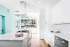Modern home with Kitchen, Marble Counter, Stone Slab Backsplashe, Dishwasher, Light Hardwood Floor, Engineered Quartz Counter, Ceiling Lighting, White Cabinet, and Range. Updated Kitchen Photo of Roanoke Park Residence