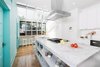 Modern home with Kitchen, White Cabinet, Dishwasher, Refrigerator, Undermount Sink, Marble Counter, Engineered Quartz Counter, Range, Light Hardwood Floor, Range Hood, and Stone Slab Backsplashe. Kitchen refresh Photo 5 of Roanoke Park Residence