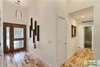 Modern home with Hallway and Light Hardwood Floor. The foyer with the custom built front door and cork wardrobe. Photo 4 of The Vickery Home