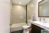 Modern home with Bath Room, Porcelain Tile Floor, Drop In Sink, Two Piece Toilet, Engineered Quartz Counter, and Porcelain Tile Wall. the guest bath featuring penny tile on the floor and tile floor to ceiling. Photo 5 of The Vickery Home