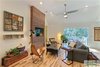 Modern home with Living Room, Chair, Coffee Tables, End Tables, Floor Lighting, and Light Hardwood Floor. The camphor entertainment wall that was built in 4 pieces so it can be transported or easily altered. Photo 11 of The Vickery Home