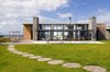Modern home with Exterior, Beach House Building Type, House Building Type, Wood Siding Material, Concrete Siding Material, Stone Siding Material, and Flat RoofLine. Main Volume Photo of La Boyita