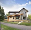 Modern home with Exterior, House Building Type, Shingles Roof Material, A-Frame RoofLine, Wood Siding Material, Stone Siding Material, Glass Siding Material, and Shed RoofLine. South street facing facade Photo 2 of The North Bridge Residence
