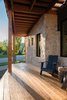 Modern home with Exterior, Metal Roof Material, Shed RoofLine, House Building Type, and Stone Siding Material. South facing front porch Photo 5 of The North Bridge Residence
