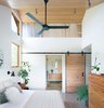 Modern home with Bedroom, Bed, Ceiling Lighting, and Concrete Floor. Master Bedroom Photo 19 of The North Bridge Residence