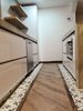 Modern home with Kitchen, Dishwasher, Concrete Counter, White Cabinet, Light Hardwood Floor, Undermount Sink, Concrete Backsplashe, and Ceiling Lighting. Kitchen Photo of Bogota downtown