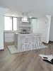 Modern home with Kitchen, Dishwasher, Cooktops, Wall Oven, Microwave, Tile Counter, White Cabinet, Light Hardwood Floor, Concrete Backsplashe, Refrigerator, Ceiling Lighting, and Undermount Sink. Kitchen Photo 8 of Bogota downtown