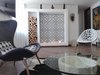 Modern home with Living Room, Ceiling Lighting, Chair, Light Hardwood Floor, and Gas Burning Fireplace. Living room, fireplace Photo 9 of Bogota downtown