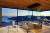 Modern home with Living Room, Chair, Coffee Tables, Recessed Lighting, Light Hardwood Floor, Two-Sided Fireplace, and Gas Burning Fireplace. A two-sided glass, gas-burning fireplace and a living room comprised of opening glass NanaWall systems. Photo 6 of Tiburon Home