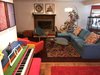 Modern home with Living Room. Painted piano (not the best angle). Art on the wall I designed, same piece served as a backdrop for our Willy Wonka inspired wedding. Bright colors tie into each other throughout the space and our offset by bright white. Our African Grey Parrot Rigby is hanging out in the back ;) Photo 3 of The Roaches world