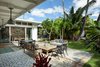 Modern home with Outdoor, Back Yard, Trees, Flowers, Gardens, Walkways, Grass, Shower Pools, Tubs, Shower, Large Patio, Porch, Deck, Pavers Patio, Porch, Deck, Metal Fences, Wall, Hanging Lighting, and Landscape Lighting. Courtyard combines indoor/outdoor living spaces Photo 2 of A Modern 1954 Plantation Style Home on Maui