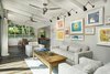 Modern home with Living Room, Sofa, Coffee Tables, Wall Lighting, and Porcelain Tile Floor. Main house living room with garden views to courtyard Photo 3 of A Modern 1954 Plantation Style Home on Maui