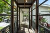 Modern home with Hallway and Porcelain Tile Floor. glass atrium walkway between master suite and living room. Photo 5 of A Modern 1954 Plantation Style Home on Maui
