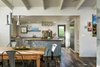 Modern home with Dining Room, Table, Chair, Pendant Lighting, and Porcelain Tile Floor. Dining area and full kitchen with Viking Gas Range and Miele Refrigerator Photo 6 of A Modern 1954 Plantation Style Home on Maui