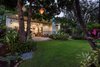 Modern home with Bedroom, Bed, Chair, Recessed Lighting, and Porcelain Tile Floor. Front lawn with vintage light fixtures and Detached 1 Bedroom/1 Bath Ohana that's 600 square feet Photo 9 of A Modern 1954 Plantation Style Home on Maui