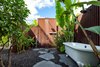 Outdoor rain shower and free standing Victoria & Albert clawfoot tub made of rust-free lava. Photo 13 of A Modern 1954 Plantation Style Home on Maui modern home