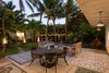 Modern home with Outdoor, Back Yard, Trees, Flowers, Grass, Gardens, Walkways, Large Patio, Porch, Deck, Metal Fences, Wall, Hanging Lighting, and Landscape Lighting. Courtyard in the evening Photo 16 of A Modern 1954 Plantation Style Home on Maui