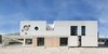 Modern home with Exterior, House Building Type, Brick Siding Material, Concrete Siding Material, Flat RoofLine, and Shingles Roof Material. the project arises as a script for the dialogue between geometry and topology, between scale and construction, between continuity and place, between time and will Photo of iA_house