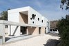 Modern home with Exterior, Metal Siding Material, Brick Siding Material, Concrete Siding Material, Flat RoofLine, House Building Type, and Shingles Roof Material. exterior Photo 9 of iA_house