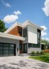 Modern home with Exterior, House Building Type, Metal Siding Material, Stucco Siding Material, Flat RoofLine, and Concrete Siding Material. Entry door, with visual cues of a stair and platform to welcome visitors and elevate them to the living level upon entry. Photo 2 of Roslyn Road Residence