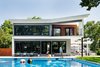 Modern home with Outdoor, Back Yard, Swimming Pools, Tubs, Shower, Hardscapes, Salt Water Pools, Tubs, Shower, Concrete Pools, Tubs, Shower, Large Pools, Tubs, Shower, Large Patio, Porch, Deck, Concrete Patio, Porch, Deck, Pavers Patio, Porch, Deck, Horizontal Fences, Wall, and Wood Fences, Wall. Rear facade, with maximum glazing and balconies to maximize daylight, views and social interaction. Photo 3 of Roslyn Road Residence