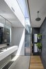 Modern home with Ceiling Lighting. Bathroom material palette of concrete, Australian white beech, slate, stainless steel, and glass illuminated from above. Photo 13 of Kihilla
