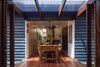 Modern home with Dining Room, Table, Medium Hardwood Floor, and Wood Burning Fireplace. Glass bridge connection between new and existing. Photo 7 of Kihilla