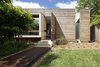 Modern home with Exterior, House Building Type, Metal Roof Material, Wood Siding Material, Concrete Siding Material, Glass Siding Material, and Flat RoofLine. Northern elevation; Australian Cypress, concrete, and river red gum. Photo 2 of Kihilla